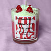 Strawberry Macaron candle with strawberry toppings on a purple background