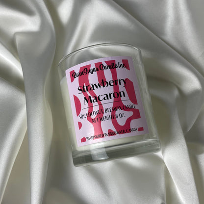 Strawberry Macaron scented candle on a silk background