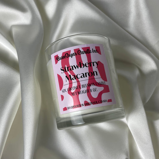 Strawberry Macaron scented candle on a silk background